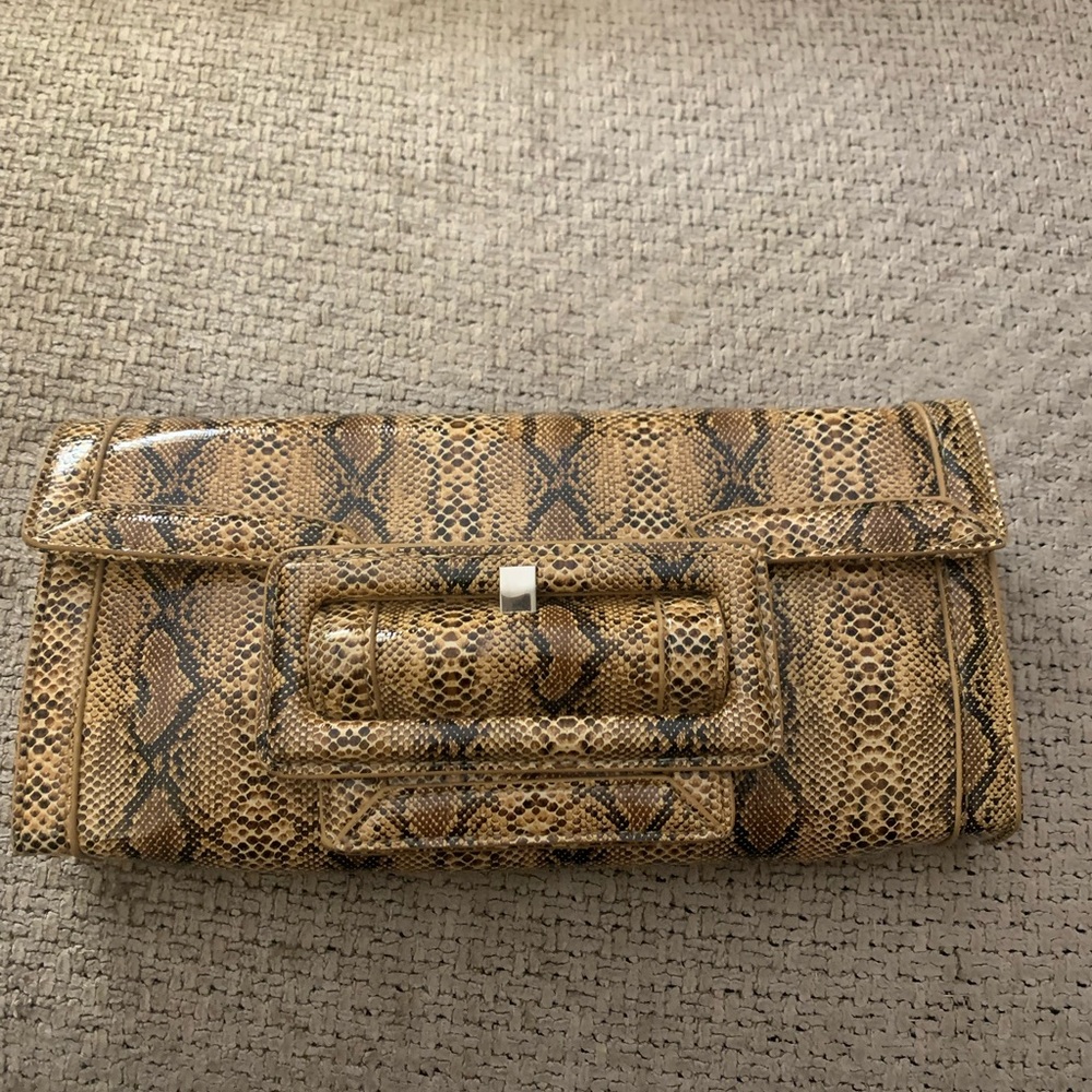 Brand new never used snake printed clutch with strap
